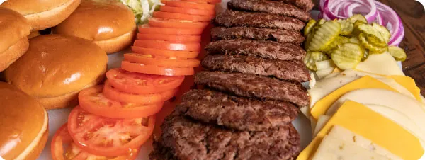 A Feed the Team bundle with a large platter of burger patties, buns and fixings