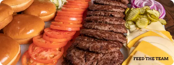 A Feed the Team bundle with a large platter of burger patties, buns and fixings