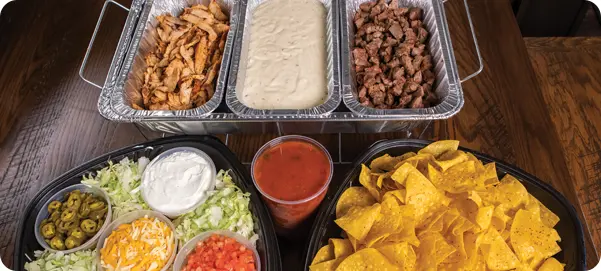 Chafing dishes full of taco fixings