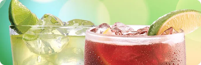 Icy glasses of Original Margarita and Red Sangria garnished with fruit slices