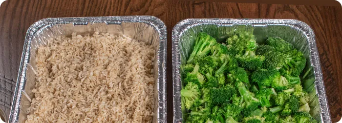 Chafing dishes of seasoned rice and steamed broccoli