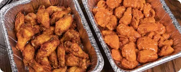 Chafing dishes holding boneless wings and traditional wings