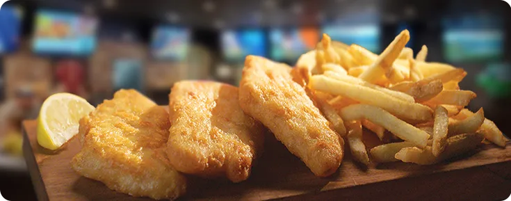 A plate of fried cod fillets and french fries
