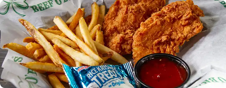 A basket of chicken tenders and fries with a Rice Krispies Treat and ketchup cup