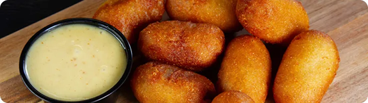 Mini corn dogs with a side of queso
