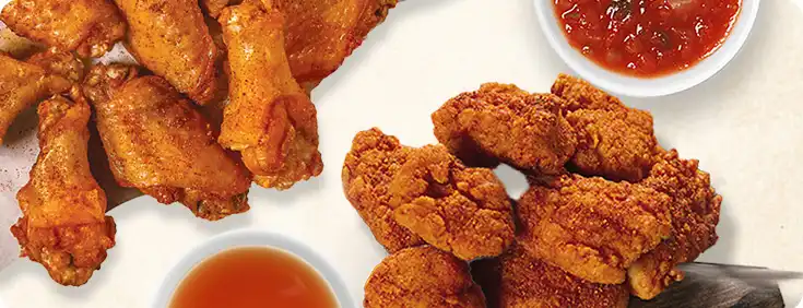 Traditional and boneless wings on a plate with sauces